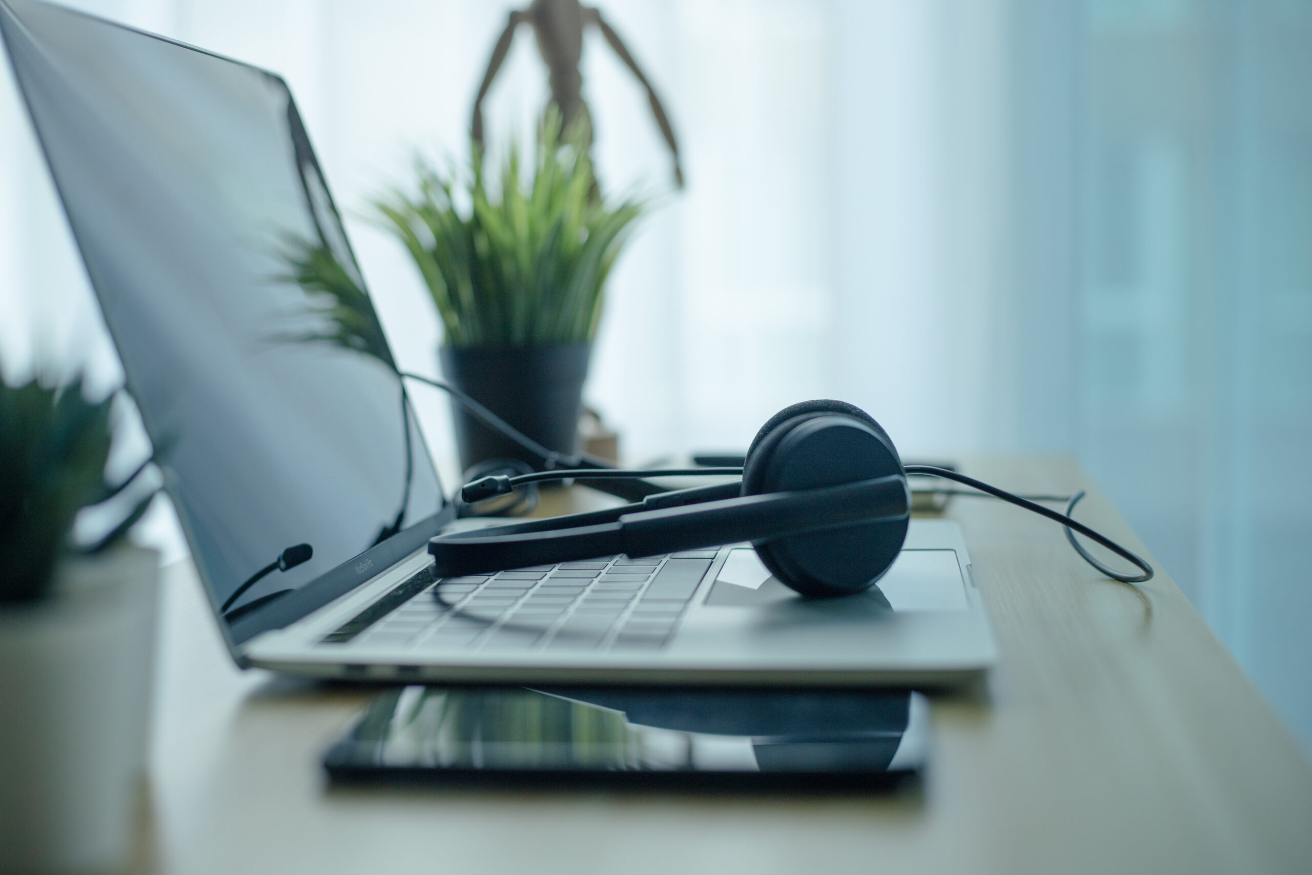 Headset headphones telephone and laptop in home office call center